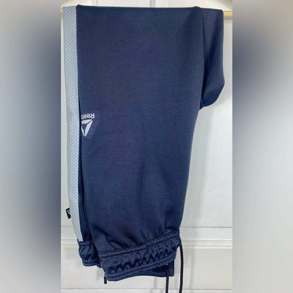 Reebok Dark Gray Stretchy Soft Track Pants. 3 pockets.  Zippers at leg base.